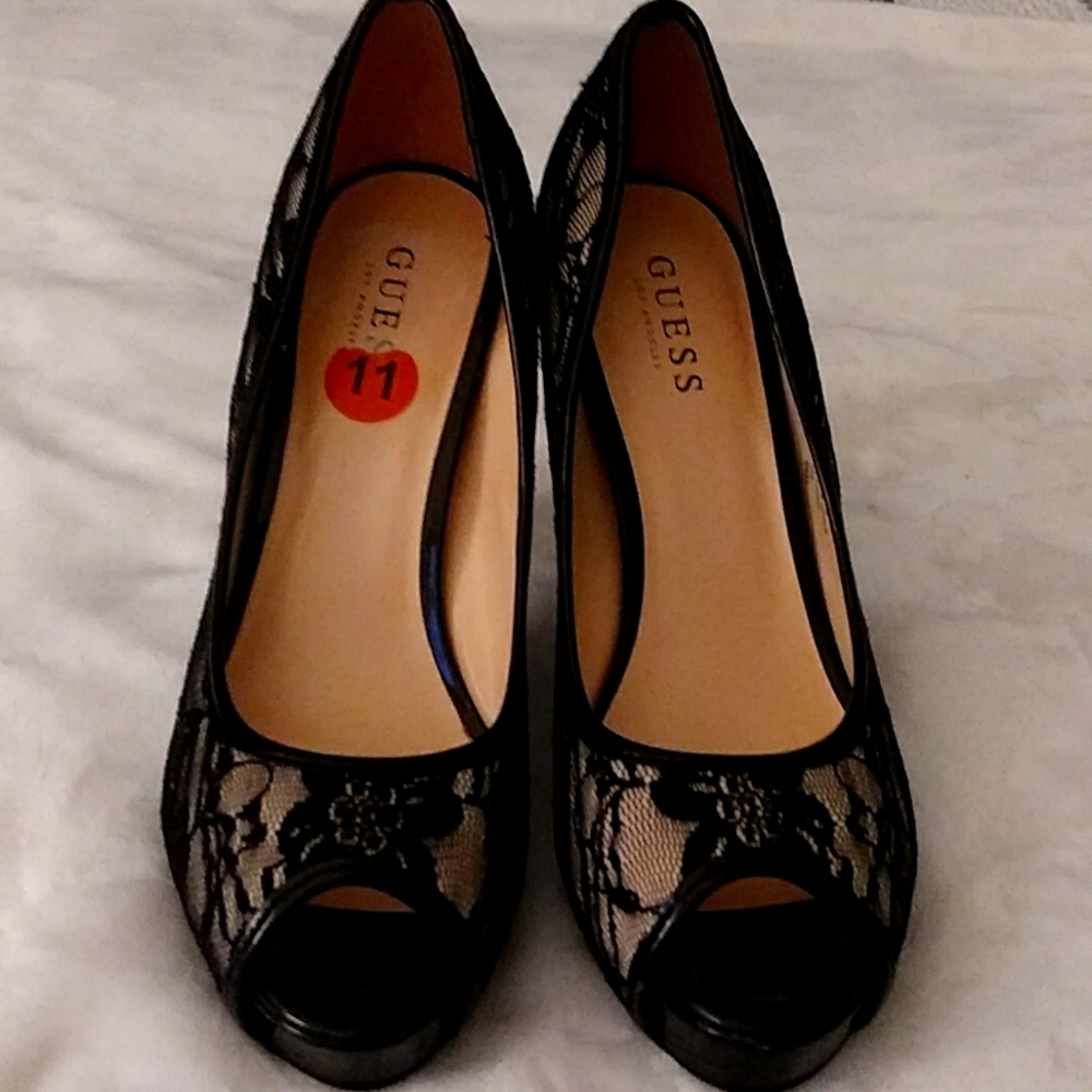 This is a plus size pair of shoe, black and white in color, and made by Guess.
